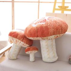 two large mushrooms sitting on top of a white couch