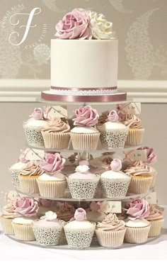 a wedding cake with cupcakes stacked on top