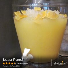 a glass filled with lemonade sitting on top of a counter