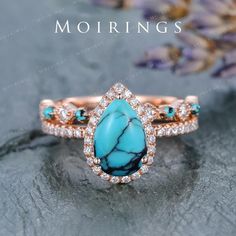 a turquoise stone and diamond ring with the words mohriings on it's side