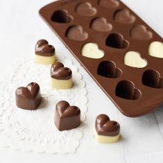 there are chocolates in the tray and hearts on the table next to it is $ 3 4