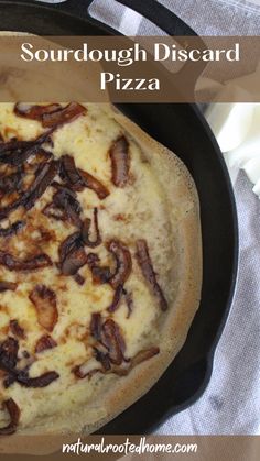 a close up of a pizza in a pan on a table