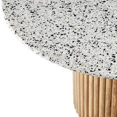 a close up of a table with black and white speckles on the top