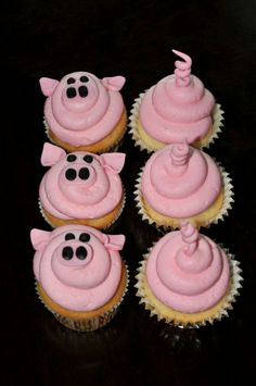 four cupcakes with pink frosting and black decorations on them, all decorated in pig shapes