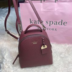 % Kate Spade Mini Caden Carter Backpack/Crossbody Bag Color: Cherrywood/Burgundy/Wine Color Interior: Fully Lined In Kate Spade Custom Fabric With Slip Pocket 8" W X 8" H X 3" D 2" Handle Drop Removable Two Way, Adjustable Shoulder Strap With 15” To 22" Drop Zip Closure With Leather Pull Pebbled Leather Exterior Hardware Is Polished Gold Tone Dust Bag Not Included. Price Is Strictly Kate Spade Burgundy Bags For Everyday Use, Kate Spade Burgundy Leather Bag, Kate Spade Standard Backpack With Detachable Strap, Kate Spade Brown Bag With Zipper Closure, Brown Kate Spade Bag With Zipper Closure, Color Interior, Burgundy Wine, Wine Color, Wine Colored