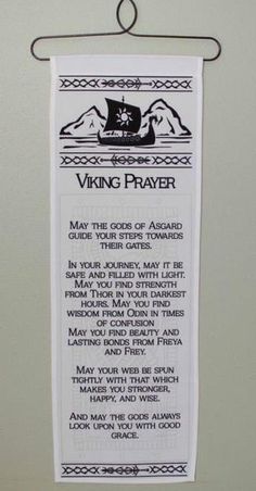 a viking prayer hanging from a hook on a wall in a room with white walls