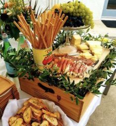 a wooden box filled with lots of different types of food on top of a table