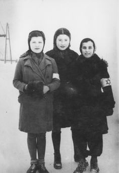 three women standing next to each other in the snow