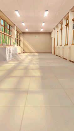 an empty hallway with windows and tiled flooring in the center is lit by recessed lights