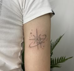 a woman's arm with a tattoo on it that has a star in the center