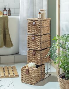 the bathroom is decorated with wicker baskets, towels and toiletries in brown leather handles