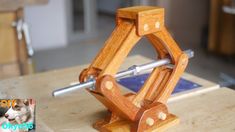 a small wooden object on top of a table with woodworking tools in the background