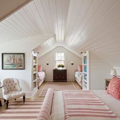 an attic bedroom with white walls and wood flooring is shown in this image, there are