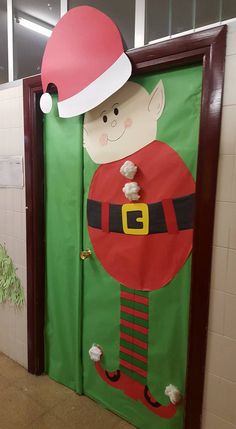 a door decorated to look like a santa clause with a hat on it's head