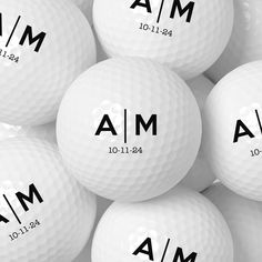 a pile of white golf balls with the names mia and mim on them in black ink