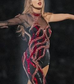 lady in black and red dress holding her arms out to the side with both hands