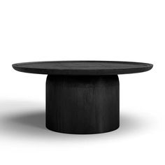 a round table with black wood on the top and bottom, in front of a white background