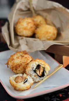 some food on a plate with chopsticks next to it and a paper bag