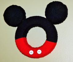 a black and red mickey mouse wreath hanging on the wall