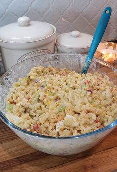 a bowl filled with macaroni and cheese on top of a wooden table