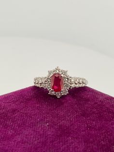 Welcome to Caviar and Cobwebs ! Thanks for stopping by. Enjoy browsing!  Here we have a gorgeous vintage ring. Crafted from 18k white gold featuring 26 round brilliant cut natural diamonds and one natural, oval-shaped brilliant cut Ruby. This ring is in size 6.5. Perfect for someone with a July birthdate. The appraisal is also included, please note the value is in Canadian dollars.  Diamond details- 0.65ctw Colour- F-G Clarity- vs1  Ruby details .59ct  Gift wrapped and shipped safe and secure from Canada. Box for display purposes only* Red Cluster Diamond Ring With Brilliant Cut, 14k White Gold Ruby Ring With Halo Setting, Ruby Ring With Diamond Cluster And Brilliant Cut, Cluster Ruby Ring With Brilliant Cut Diamonds, Cluster Ruby Diamond Ring With Center Stone, Platinum Ruby Ring With Diamond Cut, Oval Ruby Ring With Diamond Cut In Platinum, Exquisite Brilliant Cut Ruby Diamond Ring, Red Diamond Cluster Ring With Halo Setting