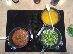 two pans filled with different types of food on top of a stove next to each other