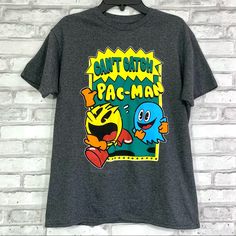 New To Poshmark? Use Code Happyoutfit To Save $10 On Your First Purchase! Pac-Man Kids / Girls / Boys Dark Gray Can’t Catch Pac-Man T-Shirt. ** Pictures Were Taken With Size Medium But There’s Other Sizes Available ** Sizes: Xs (4/5), M (8), L (10/12), Xl (14/16) Condition: New With Tags Burberry Shirt, Puma Shirts, Shirt Sayings, Candy Bars, Pac Man, T Shirts With Sayings, Nike Shirts, Boys T Shirts, Shirts With Sayings