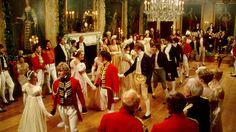 a large group of people in formal dress dancing