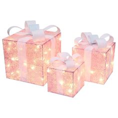 three pink gift boxes with white bows and lights