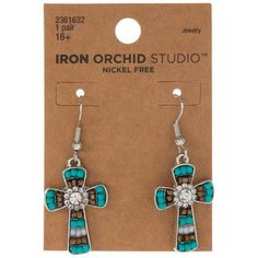 Dimensions: 1.74" x 0.71" x 0.13" Type: Ear Wire Material: Plastic & Metal Color: Turquoise, White & Charcoal Black Metal Color: Silver Age Grade: 16+ Care & Safety: Nickel-Free Quantity: 1 Pair Make any outfit stand out with these Southwest Cross Earrings! This beautiful pair of earrings is shaped like crosses with small beaded embellishments. In the center of each cross is a sparkly rhinestone that is sure to catch your attention. Pair these earrings with a pretty dress or jumpsuit for a lovel Beaded Embellishments, Paired Jewelry, Silver Age, White Charcoal, Color Turquoise, Cross Earrings, Pretty Dress, Charcoal Black, Metal Color