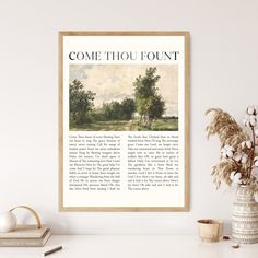 a framed book page with the words come thou fountain on it next to a potted plant