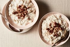 two bowls filled with oatmeal on top of a table