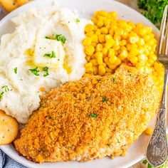 a white plate topped with chicken, mashed potatoes and corn