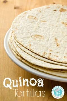 three tortillas on a white plate with the words quinoa written below