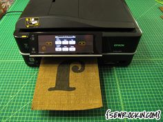 a machine that is sitting on top of a cutting mat with the number one printed on it