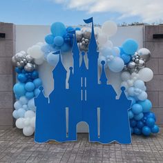 a castle made out of blue and white balloons