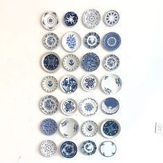 a collection of blue and white plates mounted on a wall