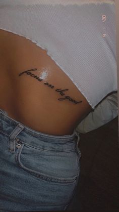 a woman's stomach with the word faith written on her lower back and side