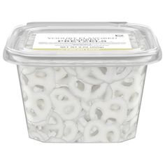 a plastic container filled with white pretzels