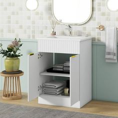 a bathroom with a sink, mirror and towel rack on the wall next to it