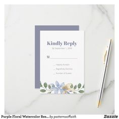 a white and blue wedding card with flowers on it next to a pen, pencil and paper