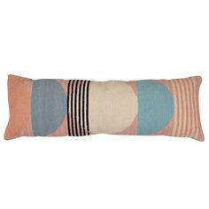 a multicolored pillow with stripes and circles on the front, sitting on a white background