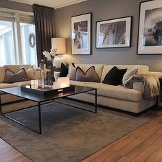 a living room with two couches and a coffee table in front of large windows