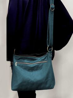 "Soft full grain Teal Leather bag Vintage tanned teal  Handmade in Australia This bag will take heavy items.   Medium size fits ipad, water bottle,  purse, phone, keys, makeup, and more *  Easy zipper closure chose your HARDWARE colour: silver  (shown in photos) gunmetal  antique brass  *  Fully Lined in your choice of fabric (see options) *  riveted leather edged inside pockets  *  1 deep outside zipper pocket *  Strong leather strap attached via solid metal rings - adjustable length. Strap: to 130cm (51 inch) x 25mm wide SIZES: measured with the bag lying flat- S M A L L bag (shown in photo) 2 inside slip pockets Size: 28 cm wide by 24 cm high (11\" x 9.5\") Depth at bottom: 5cm (2\")  M E D I U M bag (shown in photos) 3 inside slip pockets  Size: 34cm wide x 30cm (13.5 inch x 12 inch) D Turquoise Bags With Zipper Closure For Everyday Use, Everyday Turquoise Bag With Adjustable Strap, Turquoise Everyday Bag With Adjustable Strap, Everyday Turquoise Rectangular Bag, Turquoise Rectangular Everyday Bag, Dark Teal Handbag, Rings Adjustable, Teal Leather, Vintage Leather Bag