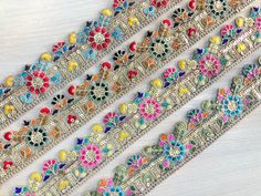 multicolored bracelets are lined up on a table