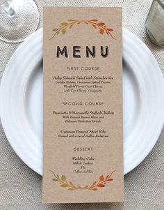 a table setting with a menu and wine glasses