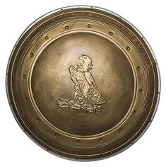 an old brass plate with a bird on it