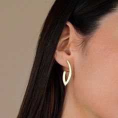 Adding a modern touch to your daily style, our 14K gold asymmetrical twisted earrings stand out with their geometric design. Attracting attention with its sparkle reflected from different angles, these earrings are a stylish accessory that you can wear both in daily life and on special occasions. Our products are completely handmade, making each one unique. Available in yellow, white or rose gold, you can choose the one that suits your personal style. The Earrings Details: ✦ Gold KT: 14k Solid G Modern Yellow Gold Wrap Earrings As Gift, Modern Yellow Gold Wrap Earrings For Gift, Modern Gold Wrap Earrings For Pierced Ears, Modern Pierced Wrap Earrings As Gift, Modern Drop Wrap Earrings For Everyday, Modern Yellow Gold Wrap Earrings, Modern Rose Gold Hoop Earrings, Modern Wrap Drop Earrings For Everyday, Modern Wrap Earrings For Everyday