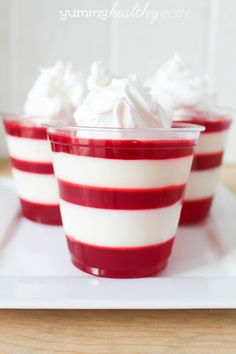 red and white dessert cups with whipped cream in them