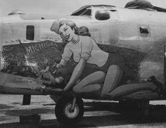 an old airplane with a woman painted on the side